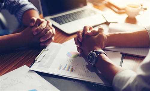 hands on table with laptop representing Negotiation course by Commerce Edge||Negotiation Skills